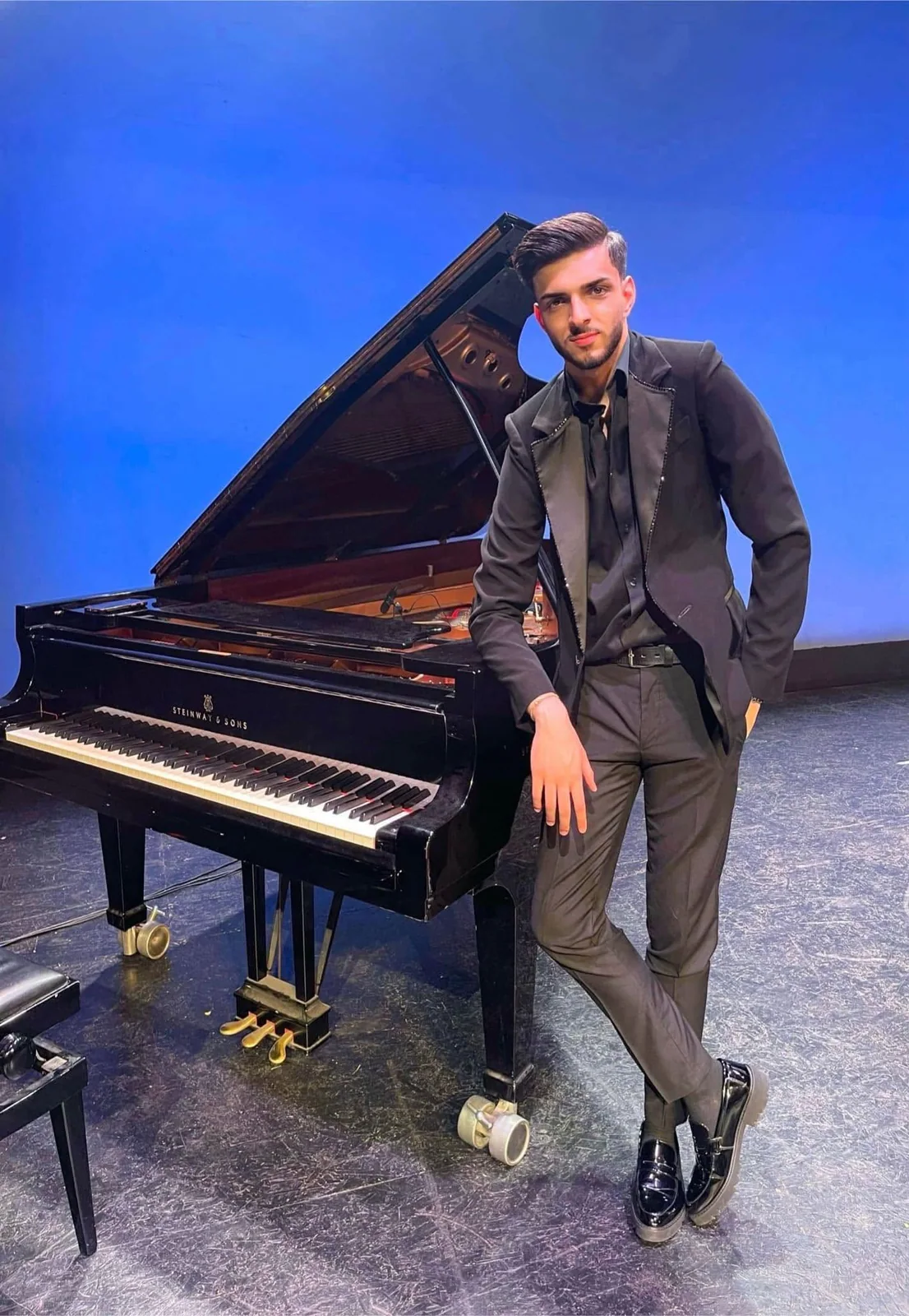 Albert Gugulan beside a Steinway piano.